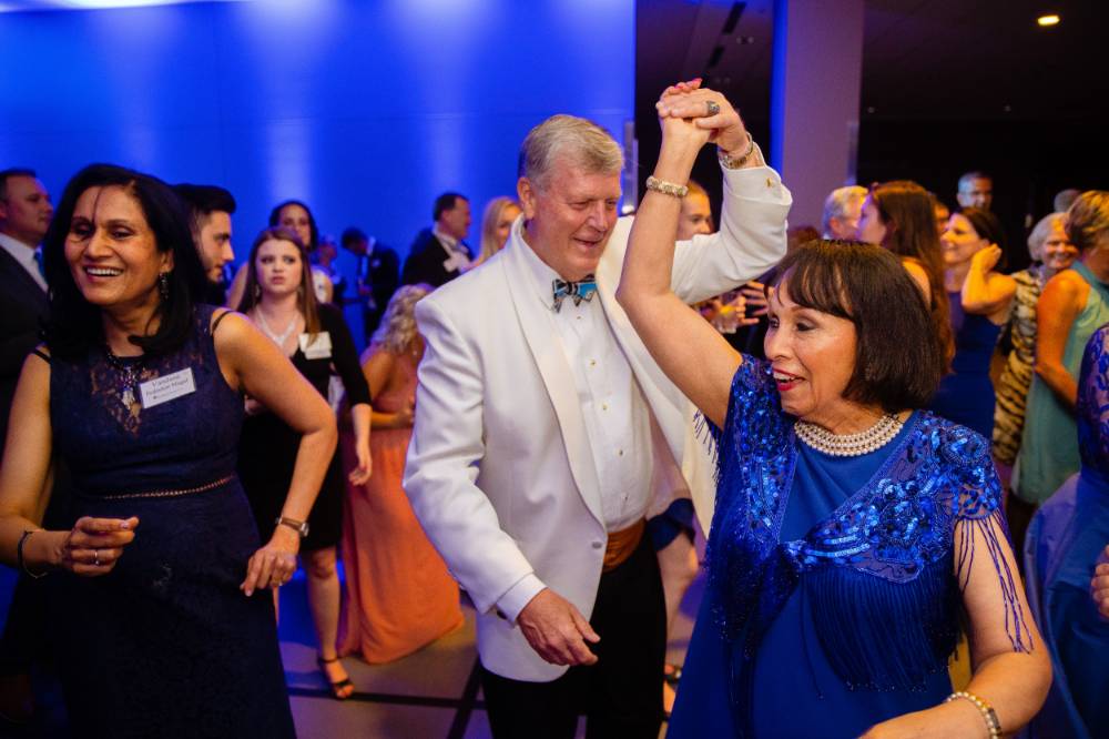President Tom Haas dancing with guest at Enrichment